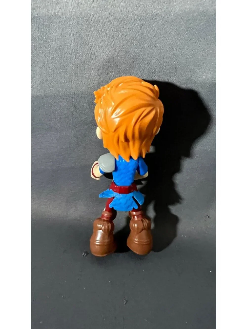 Red-Haired Action Figure In Blue Outfit With Brown Boots